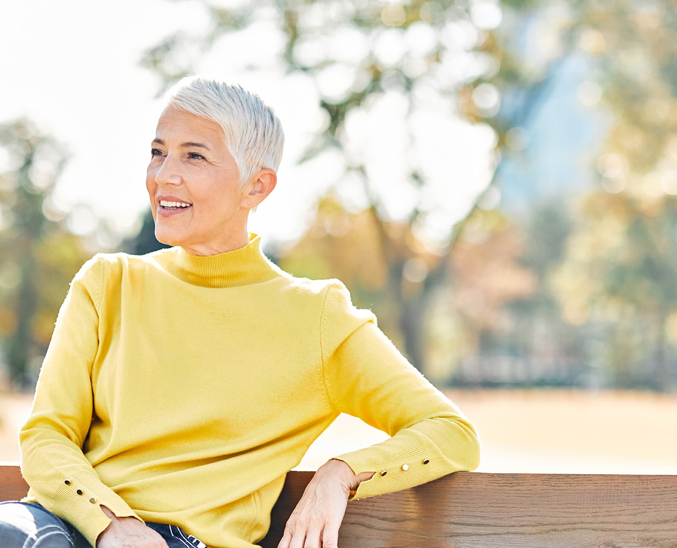 woman in a bright yellow sweater smiling in Phoenix, AZ