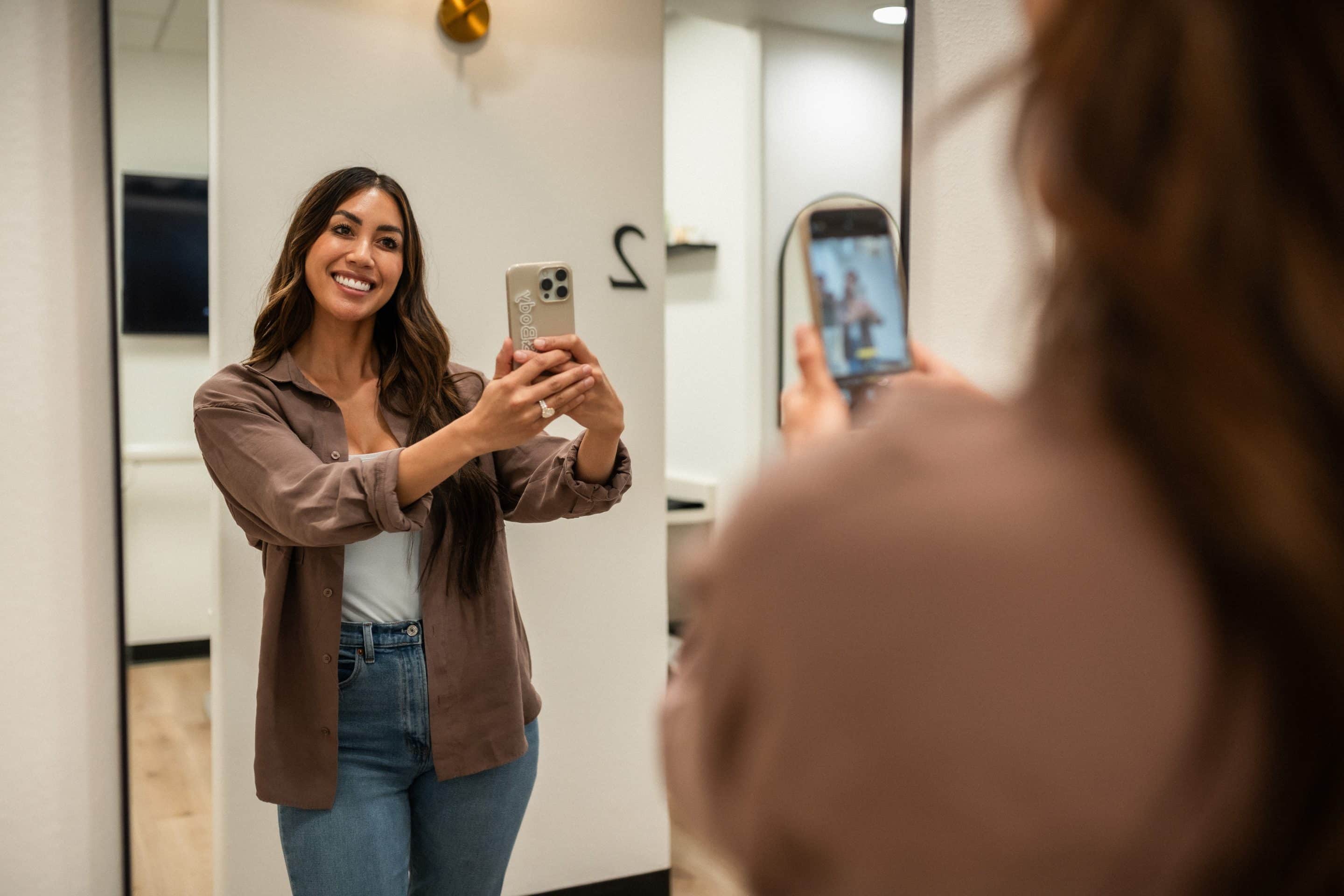 dental patient taking a mirror selfie after botox dental injectibles at the smile studio